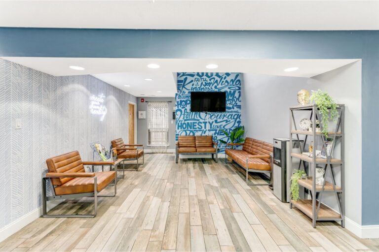comfortable lounge with tv and seating in drug and alcohol rehab facility, all in solutions counseling center cherry hill