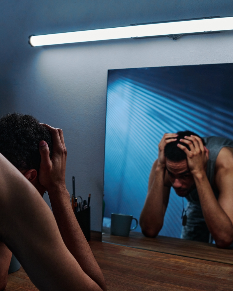 man upset in front of mirror PTSD treatment substance abuse all in solutions